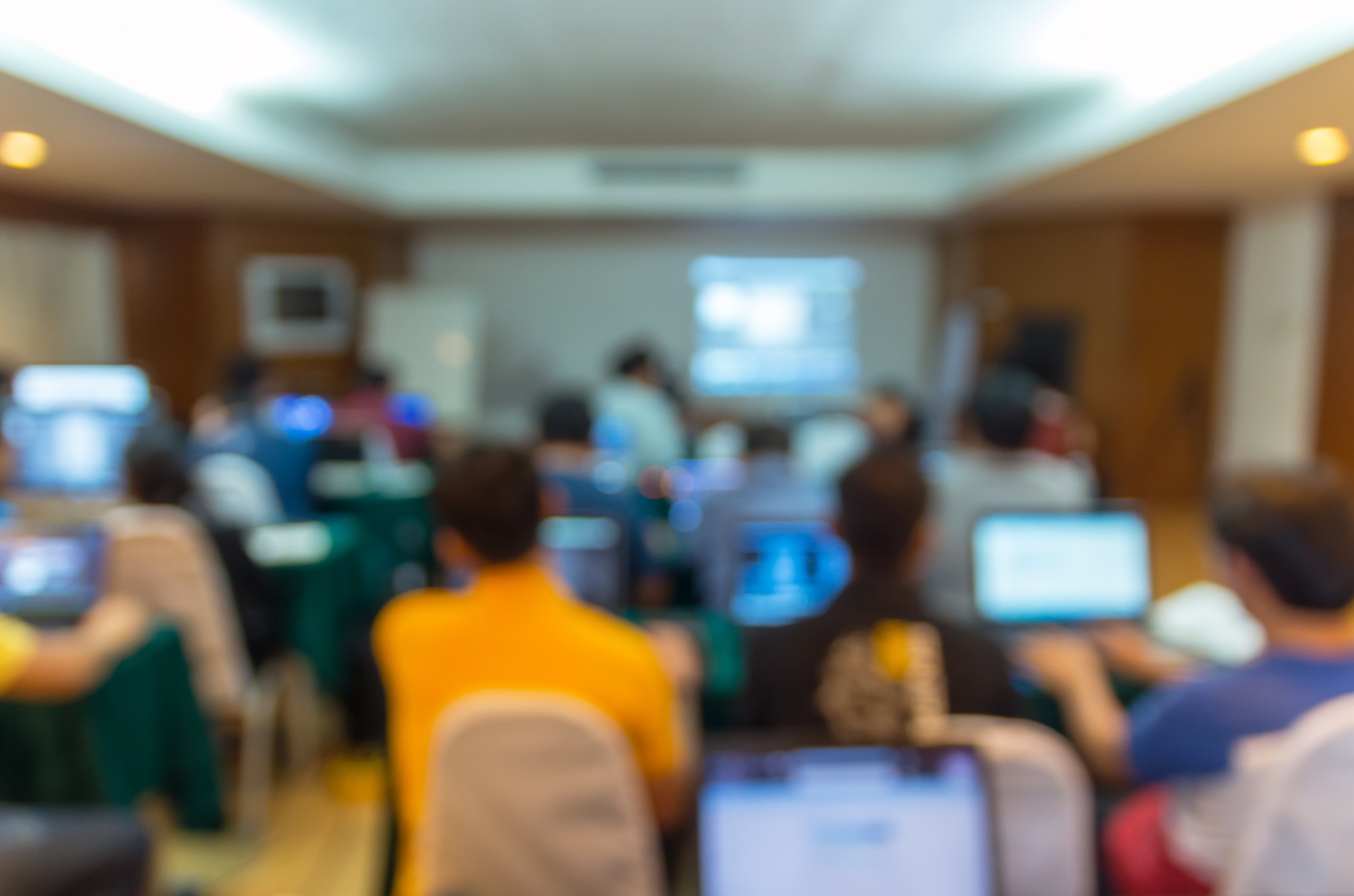 Abstract blurred photo of conference hall or seminar room with attendee background